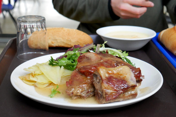 Roasted pork ribs with baked potatoes and salad